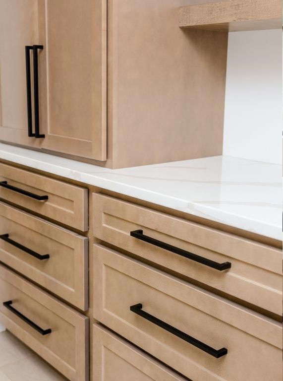 Close up view of drawers & cabinets featuring black hardware that was installed in a lake home near Otter Tail City, Minnesota.